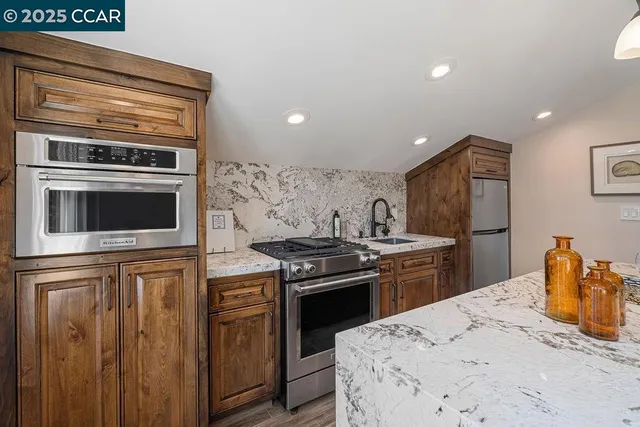 a front view of a house with yard and green space