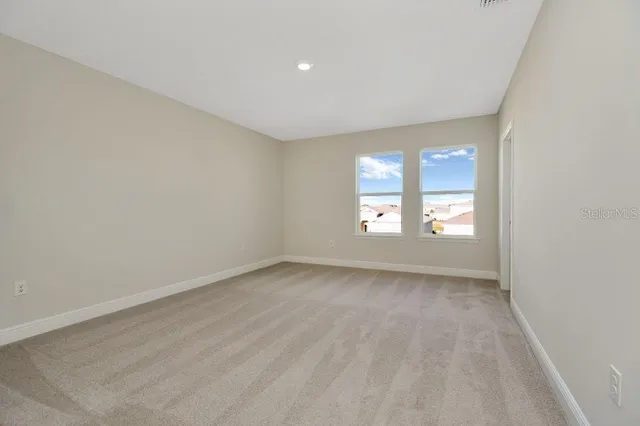 a view of a big room with closet and windows