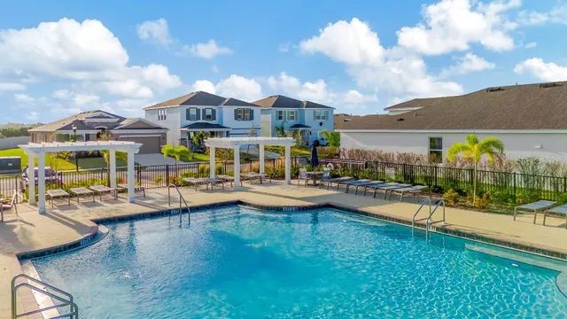 a swimming pool view with a outdoor seating