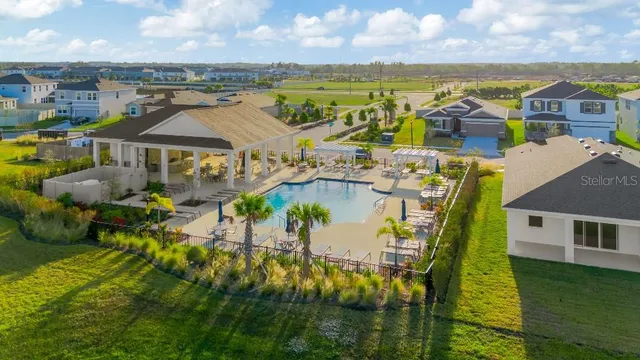 a swimming pool with outdoor seating and yard
