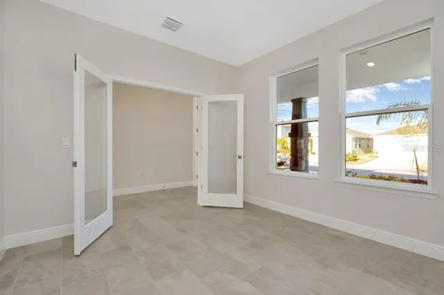 an empty room with windows and closet