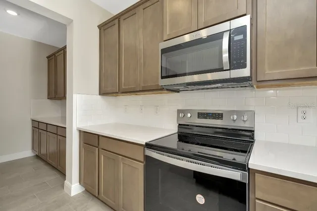 a kitchen with a stove microwave and sink
