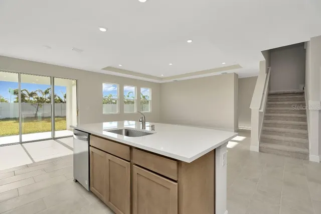 a kitchen with a sink and a refrigerator