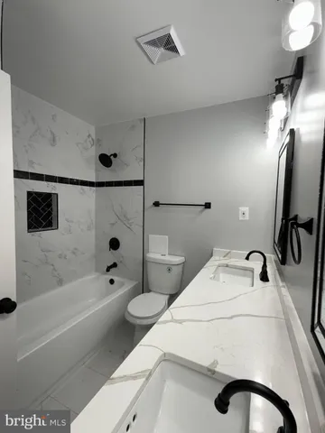 a bathroom with a sink a toilet and a bathtub