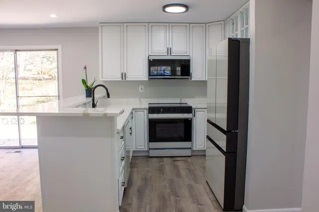 a kitchen with a stove and a refrigerator