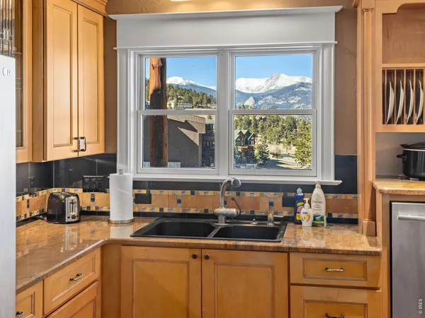 a kitchen with sink a window and cabinets