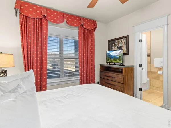 a bedroom with a bed and a dresser