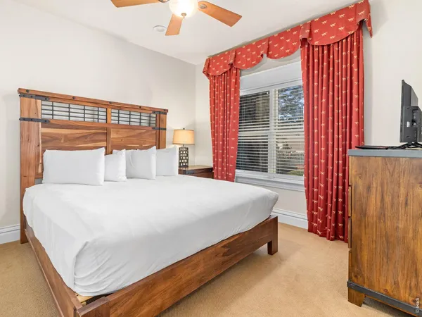 a bed sitting in a bedroom next to a window