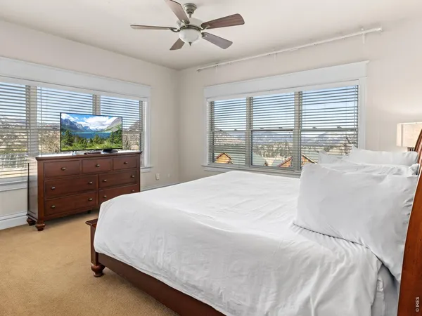 a spacious bedroom with a bed and window