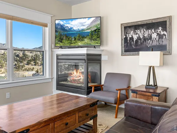 a living room with furniture a window and a fireplace