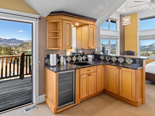 a kitchen with sink a window and cabinets
