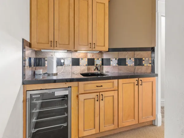 a kitchen with granite countertop stainless steel appliances white cabinets and sink