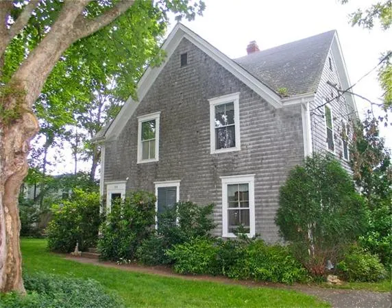 a aerial view of a house next to a yard