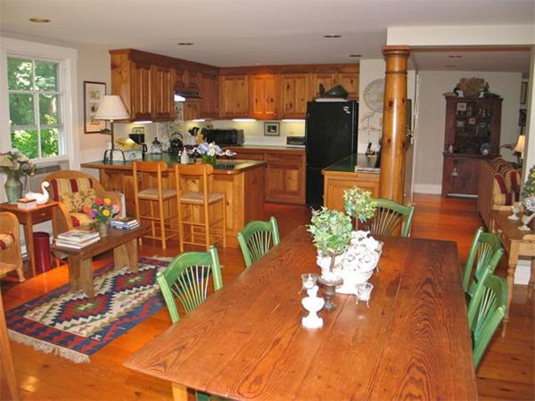 709 Old County Road West Tisbury, MA 02568 - Photo 8 of 22 a view of a dining room with furniture a kitchen and chandelier