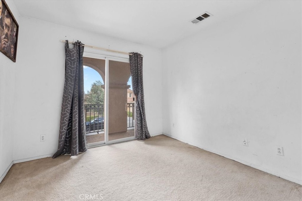 1474 Albillo Loop Perris, CA 92571 - Photo 22 of 35 a view of an empty room with a window