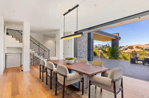a kitchen filled with stainless steel appliances granite countertop a stove and a wooden cabinets
