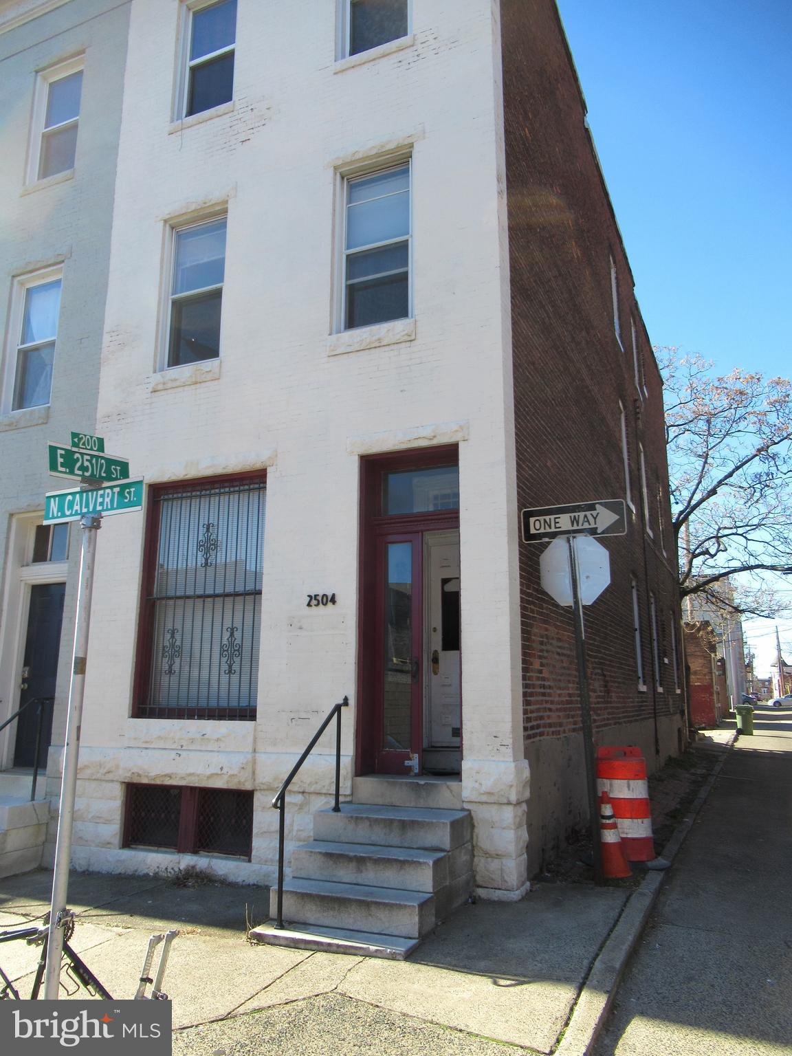2504 North Calvert Street, Unit 1 Baltimore, MD 21218 - Photo 1 of 13 a front view of a house with a garden