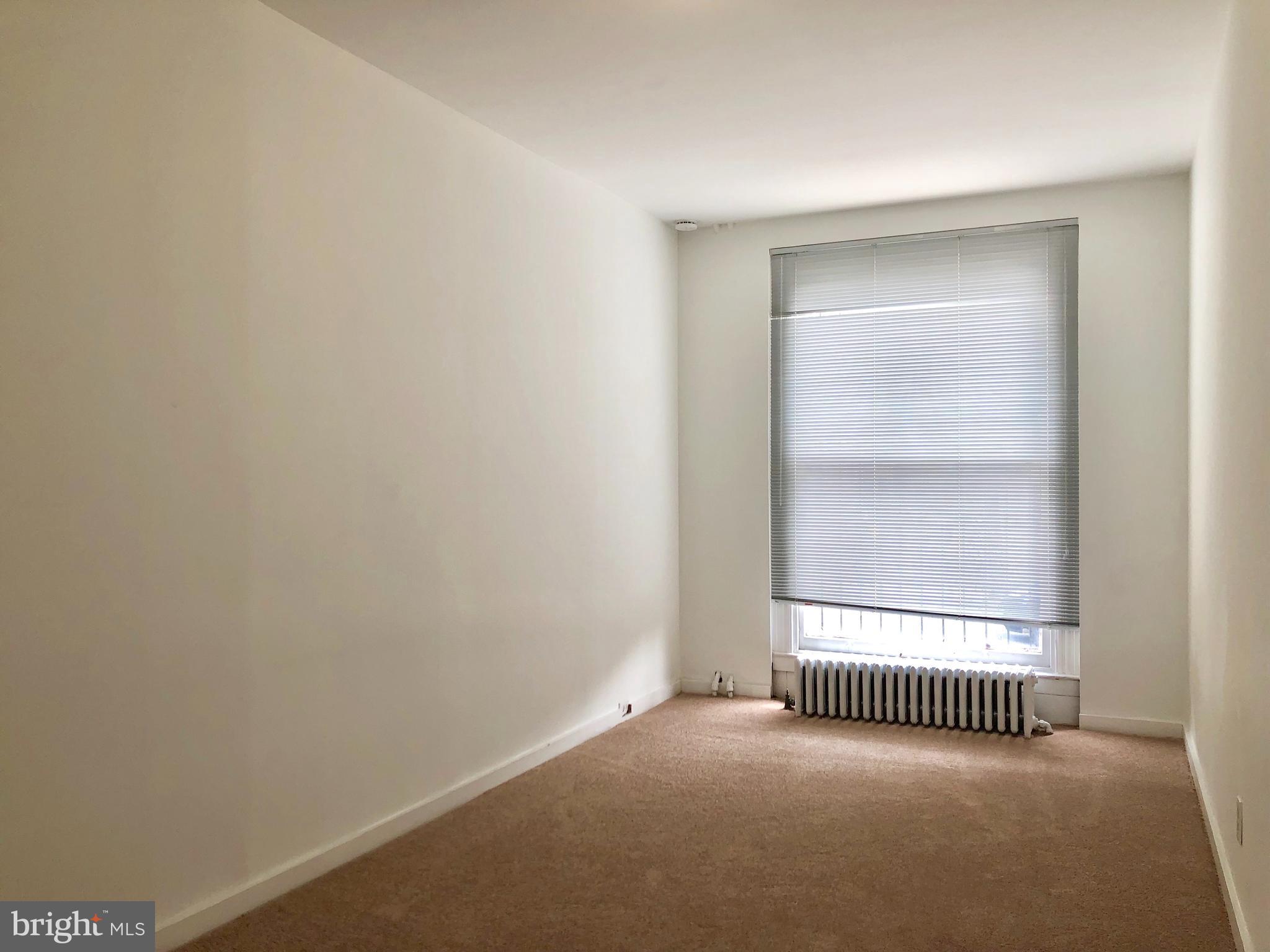 2504 North Calvert Street, Unit 1 Baltimore, MD 21218 - Photo 2 of 13 a view of a room with a large window