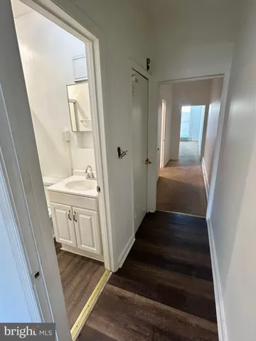 a view of a hallway view with wooden floor and staircase