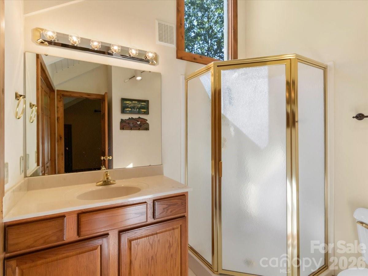 121 Ivy Ridge Road Burnsville, NC 28714 - Photo 34 of 48 a bathroom with a sink and a mirror