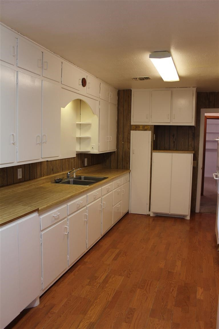 301 Chestnut Street Ropesville, TX 79358 - Photo 2 of 9 a kitchen with stainless steel appliances granite countertop a sink and a stove