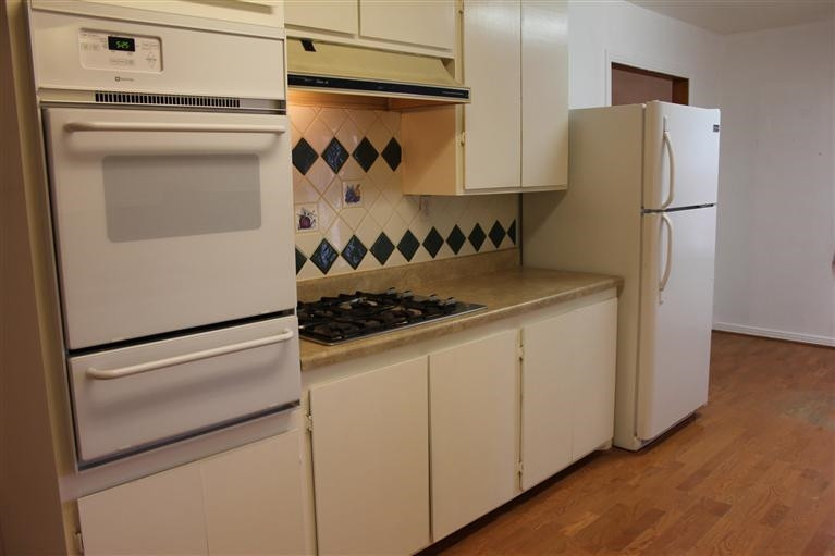 301 Chestnut Street Ropesville, TX 79358 - Photo 3 of 9 a kitchen with a refrigerator and a stove