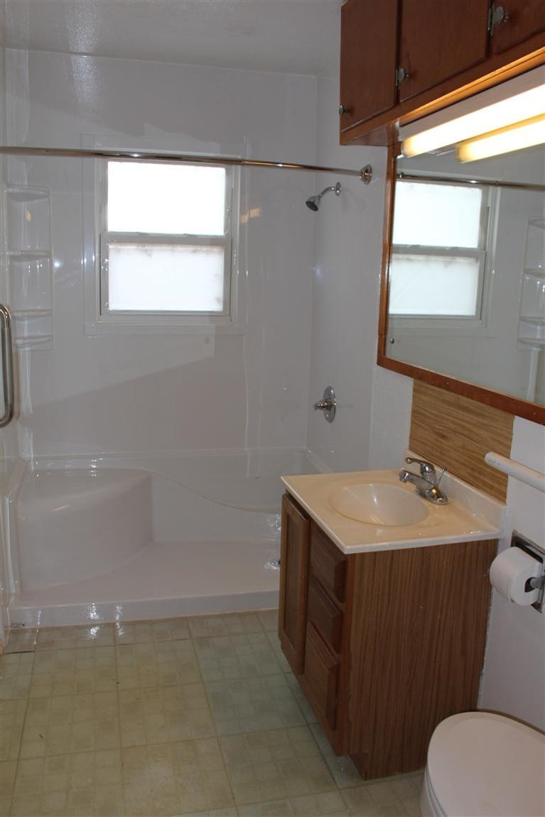 301 Chestnut Street Ropesville, TX 79358 - Photo 7 of 9 a bathroom with a sink toilet vanity and window
