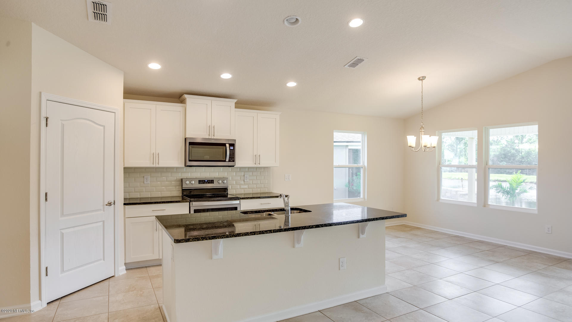 410 Palace Drive St. Augustine, FL 32084 - Photo 5 of 29 a kitchen with stainless steel appliances granite countertop a refrigerator and a stove top oven