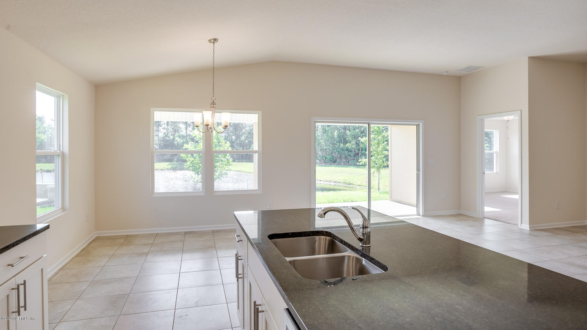 410 Palace Drive St. Augustine, FL 32084 - Photo 8 of 29 a kitchen with granite countertop a sink and a window