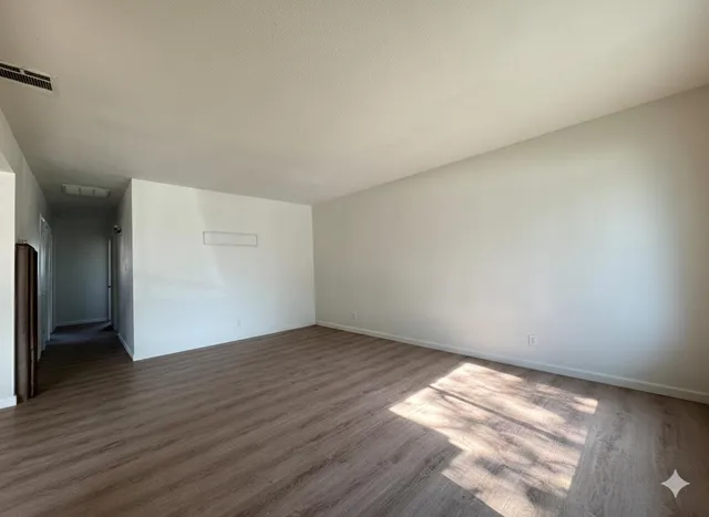 a view of an empty room and wooden floor