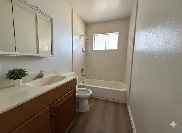 a bathroom with a sink a toilet and a bathtub