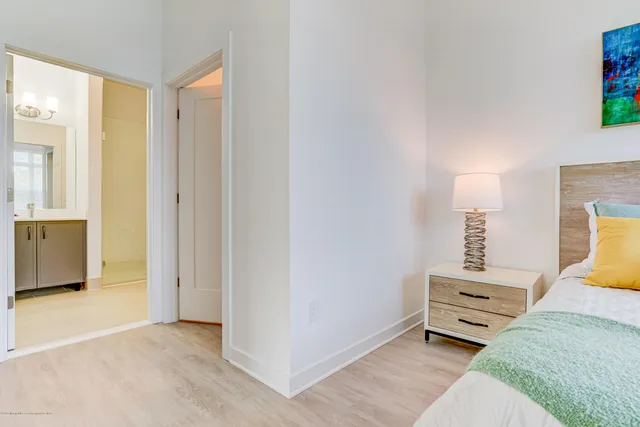 a bedroom with a bed and a lamp