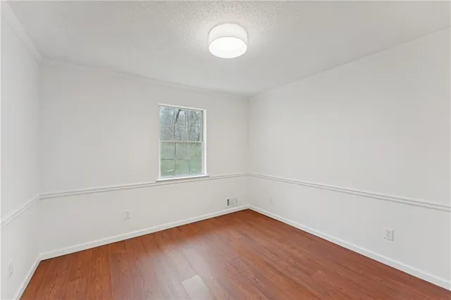 a view of a chandelier in a room with wooden floor