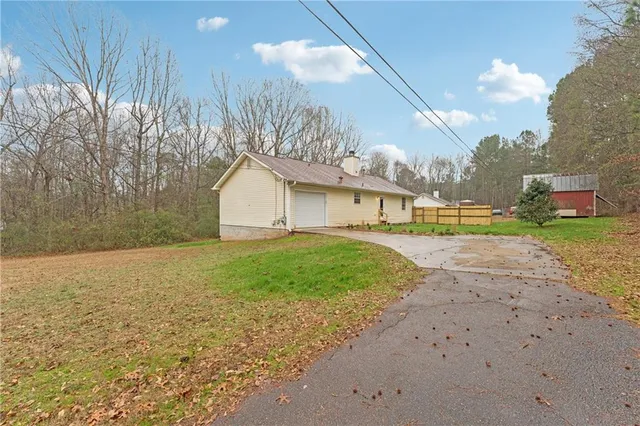 a view of a backyard with table and chairs with wooden fence