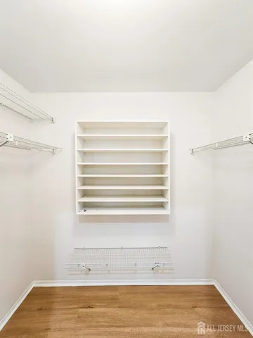 a view of a small space with wooden floor and a window