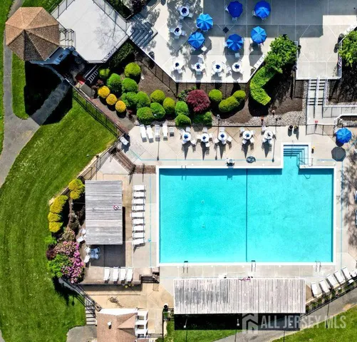 an aerial view of a house with a garden and lake view