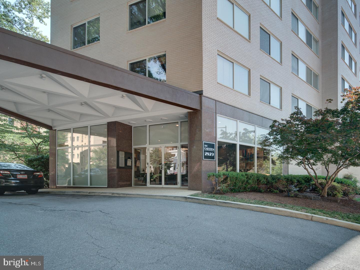 2829 Connecticut Avenue Northwest, Unit 606 Washington, DC 20008 - Photo 1 of 28 a view of a building with a cars park side of a road