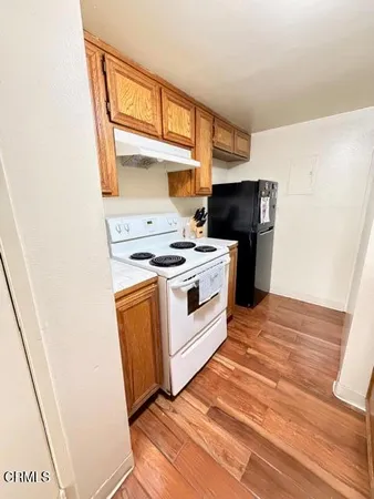 a kitchen with stainless steel appliances a stove a sink and a refrigerator