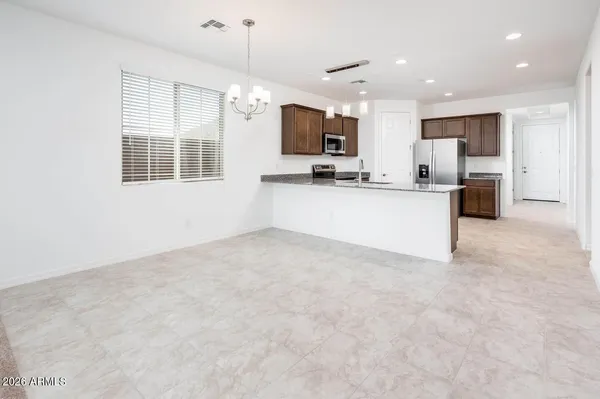 a view of kitchen with sink refrigerator and microwave