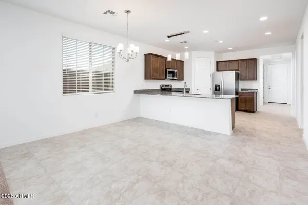 a view of kitchen with sink refrigerator and microwave