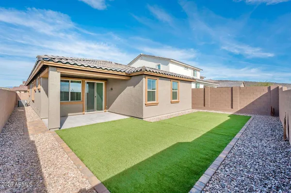 a front view of a house with a garden and yard