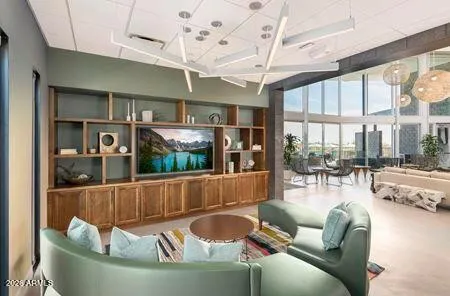 a living room with furniture a rug and kitchen view