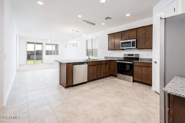 a large kitchen with cabinets and stainless steel appliances