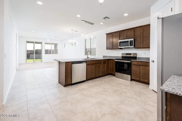 a large kitchen with cabinets and stainless steel appliances
