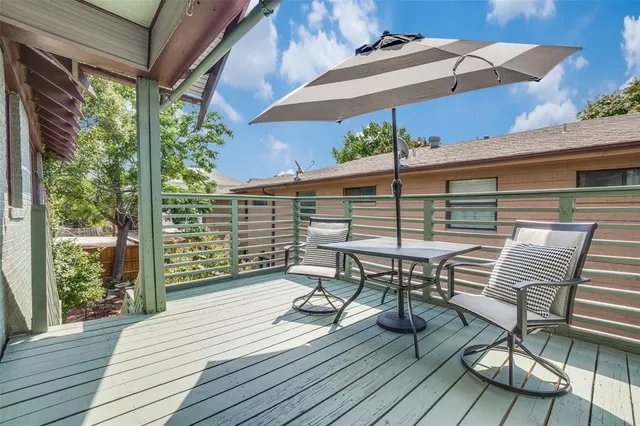 a view of balcony with wooden floor and outdoor seating
