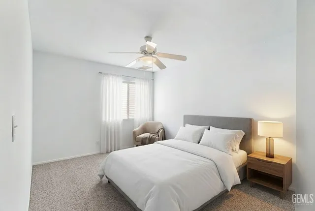 an empty room with cabinet and chandelier fan