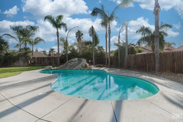 a backyard of a house with table and chairs