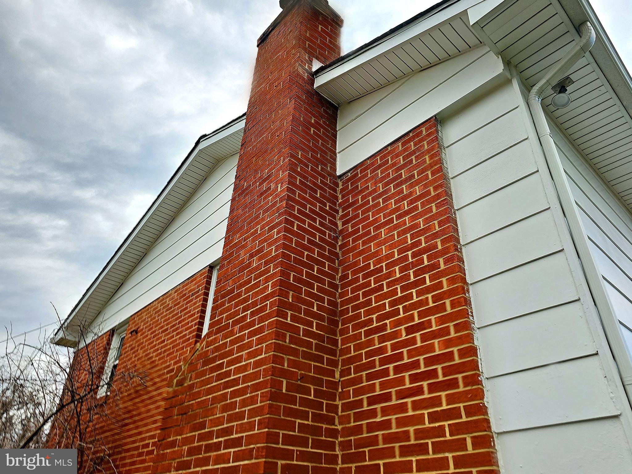 14143 Grayson Road Woodbridge, VA 22191 - Photo 15 of 58 Brick chimney for wood burning fireplace.