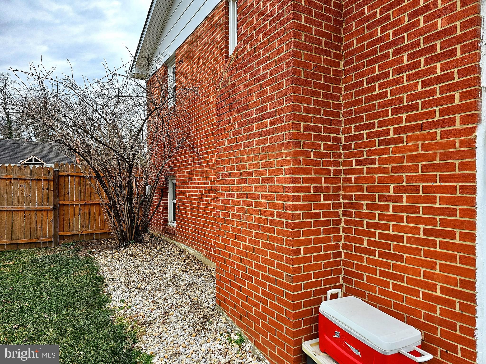 14143 Grayson Road Woodbridge, VA 22191 - Photo 17 of 58 Side view, from backyard, of brick home.