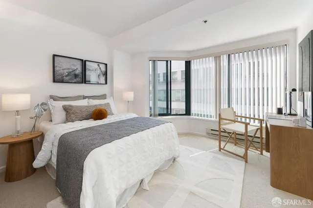 a spacious bedroom with a large bed and a large window